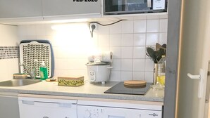 A kitchen with a dishwasher, a microwave, and a sink.