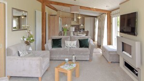 A modern living room with a sofa, a coffee table, and a fireplace.