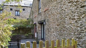 A stone building with a wooden gate labeled "DRAY." - 4 bedroom accommodation in East Allington, near Totnes (East Allington, near Totnes)