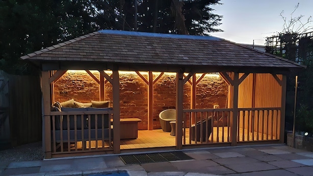 A covered outdoor seating area with a pool in the foreground. - Greenlands Farmhouse (Barmby Moor, York)
