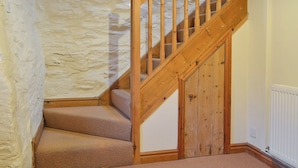 Una escalera de madera con peldaños alfombrados que conducen a una plataforma.