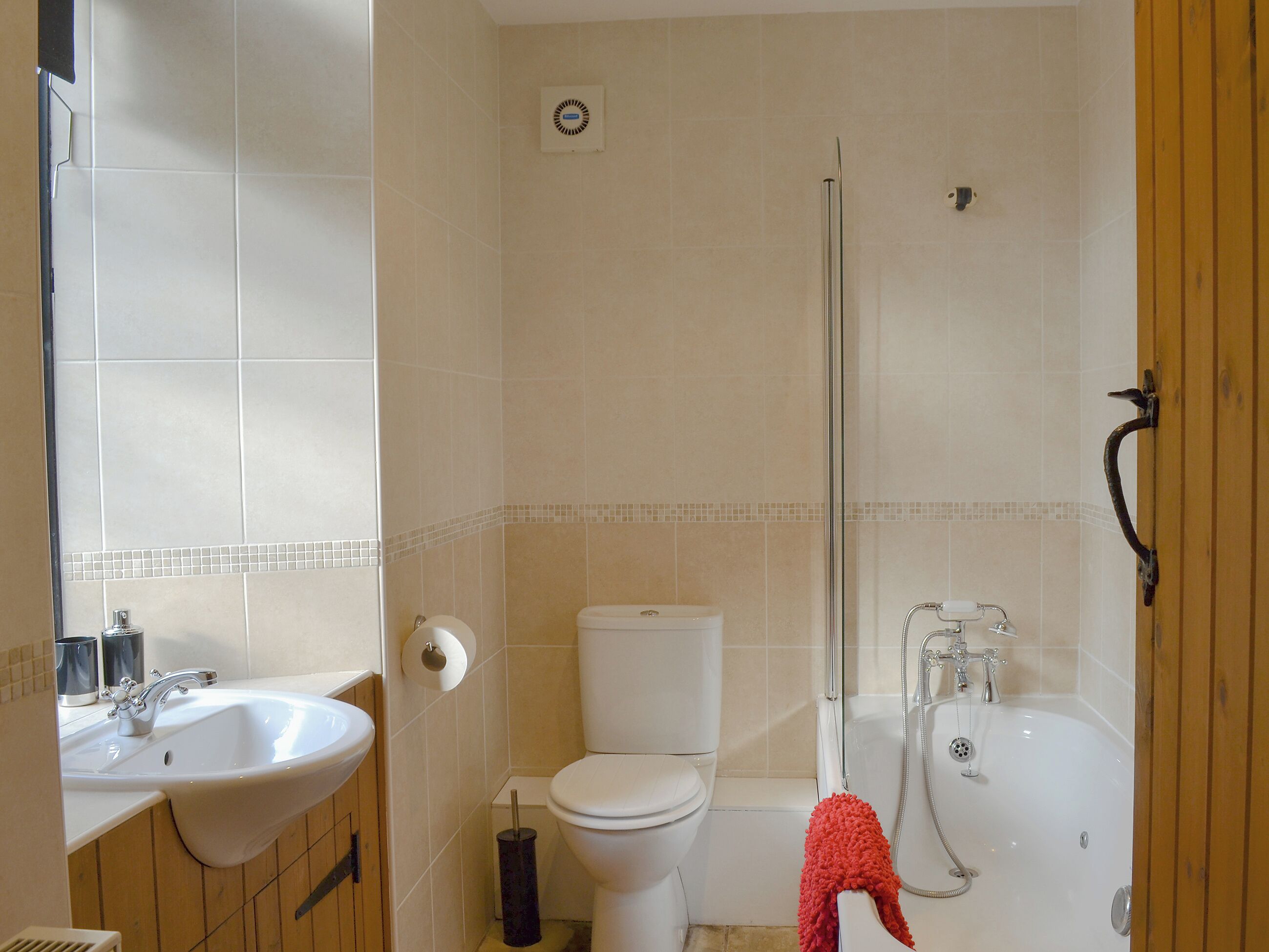 A bathroom with a sink, toilet, and bathtub.
