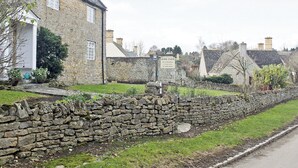 A stone house with a sign indicating it is a bed and breakfast. - Dusty's Stable - E4751 (Ebrington, near Chipping Campden)