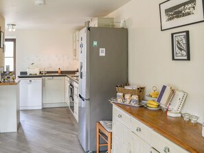 A kitchen with a refrigerator, dishwasher, and wooden countertop. - 3 bedroom accommodation in Shilbottle, near Alnwick (Shilbottle, near Alnwick)