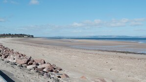 A wide sandy beach with a rocky shoreline and distant hills. - 2 bedroom accommodation in Keith (Keith)