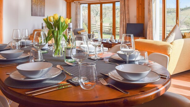 A dining table set for a meal with multiple bowls, glasses, and cutlery. - 4 bedroom accommodation in Balmullo, near St Andrews (Balmullo, near St Andrews)
