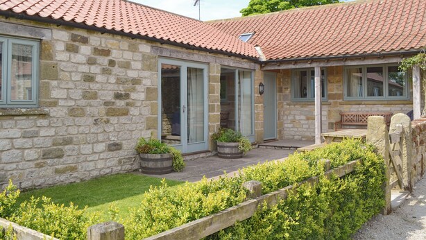 A stone building with a tiled roof, a wooden fence, and a well-maintained garden. - 3 bedroom accommodation in Spaunton, near Lastingham (Spaunton, near Lastingham)