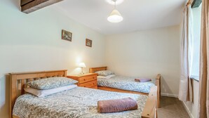 A bedroom with two beds, a nightstand, a lamp, and a ceiling fan. - Granary Cottage - E5634 (Chittlehampton, near Umberleigh)
