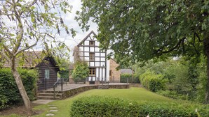 A traditional half-timbered house with a stone staircase leading to a wooden deck. - 5 bedroom accommodation in Mathon, near Malvern (Mathon, near Malvern)
