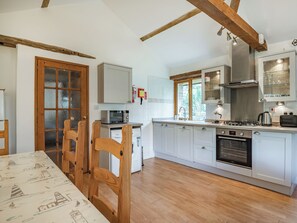 A kitchen with white cabinets, a microwave, a stove, and a dishwasher.