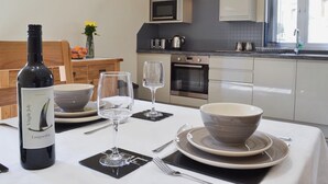 A modern kitchen with white cabinets, a built-in oven, and a window. - 2 bedroom accommodation in Cilcennin, near Aberaeron (Cilcennin, near Aberaeron)