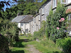 A traditional stone building with a garden path leading to the entrance.