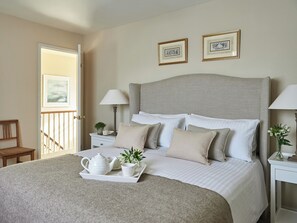 A neatly arranged bedroom with a bed, bedside tables, lamps, and framed pictures on the wall. - 3 bedroom accommodation in Pickering (Pickering)