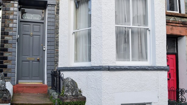 A corner house with a grey door, white walls, and a red door. - 3 bedroom accommodation in Keswick (Keswick)