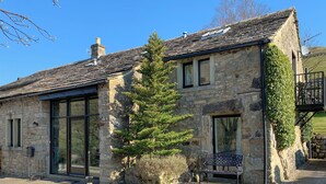 A stone building with large windows, a chimney, and a tree in front. - 3 bedroom accommodation in Starbotton, near Skipton (Starbotton, near Skipton)