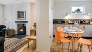 Una cocina moderna con comedor, chimenea y vistas al exterior.