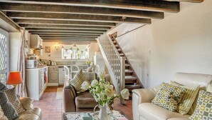 A cozy living room with a fireplace, a dining area, and a kitchen. - 2 bedroom accommodation in Gowerton, Gower (Gowerton, Gower)