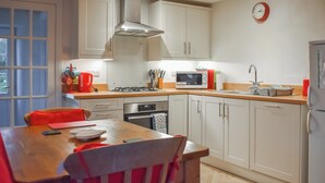 A modern kitchen with white cabinets, a gas stove, a microwave, and a sink. - 1 bedroom accommodation in Once Brewed, Bardon Mill, near Hexham (Once Brewed, Bardon Mill, near Hexham)