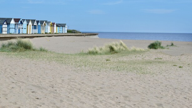 A beach with a row of colorful beach huts and a sandy beach. - 2 bedroom accommodation in West Ashby, near Horncastle (West Ashby, near Horncastle)