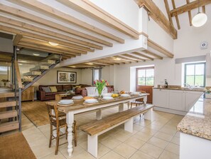 A spacious kitchen with a dining area, wooden beams, a staircase, and a view of the outdoors. - 7 bedroom accommodation in Bradbourne, near Ashbourne (Bradbourne, near Ashbourne)