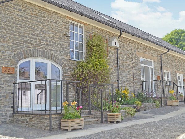 A stone building with a sign reading "The Granary."