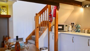 A kitchen with wooden cabinets, a microwave, and a coffee maker.