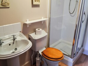 A bathroom with a sink, toilet, and shower.