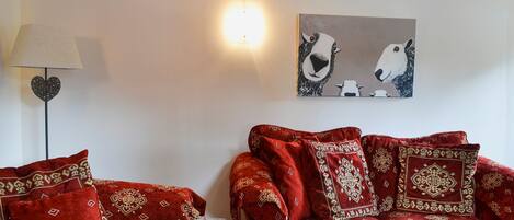 Welcoming living room with cosy wood burner | West End Cottage, Carrbridge, near Aviemore