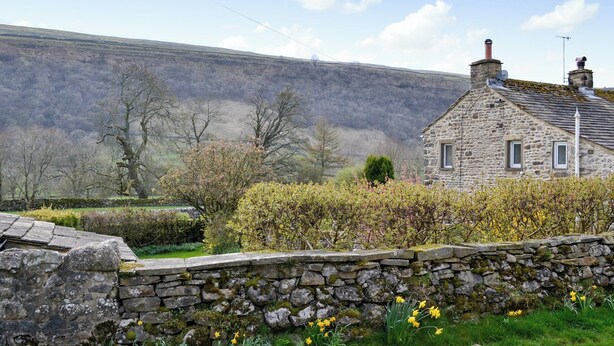A stone house with a sloped roof, a chimney, and a small window. - 2 bedroom accommodation in Starbotton, near Skipton (Starbotton, near Skipton)