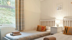 A bedroom with two beds, each with a pillow featuring the letters "NAP". - 3 bedroom accommodation in Beech Hill, near Bowness-on-Windermere (Beech Hill, near Bowness-on-Windermere)
