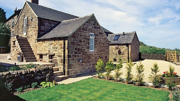 A stone house with a sloped roof, a visible staircase, and a well-maintained lawn. - Spring Cottage-E3846 (Kirk Ireton, near Matlock)
