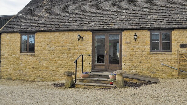A stone building with a tiled roof, a front door, and two windows. - 1 bedroom accommodation in Ebrington, near Chipping Campden (Ebrington, near Chipping Campden)