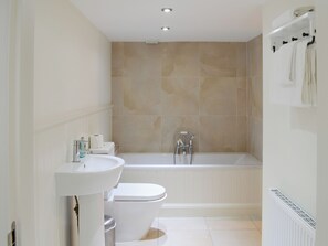 A modern bathroom with a bathtub, toilet, and sink. - 4 bedroom accommodation in Rispond, near Durness (Rispond, near Durness)