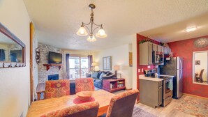 A compact kitchen with a dining area, a built-in microwave, and a refrigerator. - Affordable, updated, quiet, location, location, location! (steamboat springs)