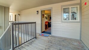 A wooden deck with a metal railing, a welcome mat, and a door leading to an interior space. - Affordable, updated, quiet, location, location, location! (steamboat springs)