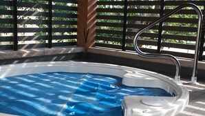 A hot tub with a metal ladder and a white cover. - Affordable, updated, quiet, location, location, location! (steamboat springs)