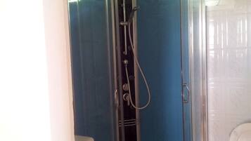 Shower, hair dryer, towels, toilet paper
