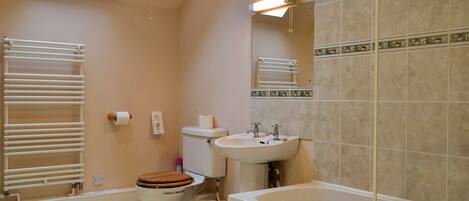 A bathroom with a toilet, sink, and bathtub.