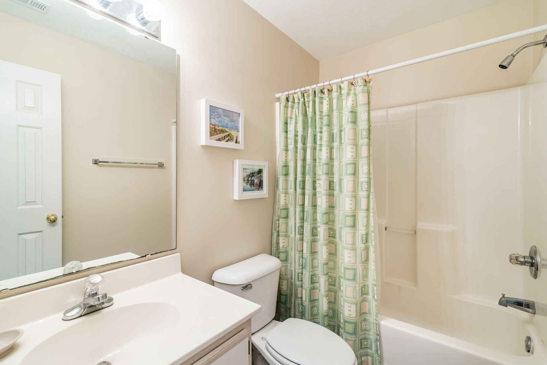 A bathroom with a toilet, sink, and shower.