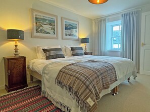 A bedroom with a bed, two bedside lamps, a window with curtains, and two framed pictures on the wall. - 1 bedroom accommodation in Rispond, near Durness (Rispond, near Durness)