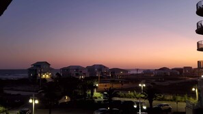 Houses line the coastal shoreline, offering ocean views and a quiet residential atmosphere.