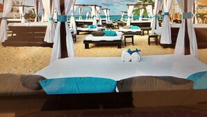 A beachside hotel room with a bed, two lounge chairs, and a view of the ocean. - Beautiful Punta Cana Beach Escape! (El Cortecito)