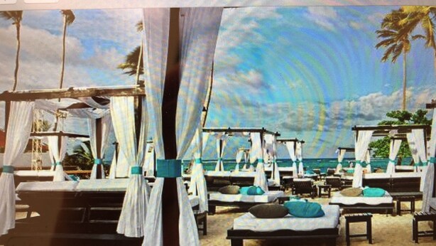 A beachside hotel room with multiple beds, a view of the ocean, and palm trees. - Beautiful Punta Cana Beach Escape! (El Cortecito)
