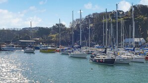 A marina with multiple boats docked, a clear sky, and a hilly landscape in the background. - 2 bedroom accommodation in Ilfracombe (Ilfracombe)