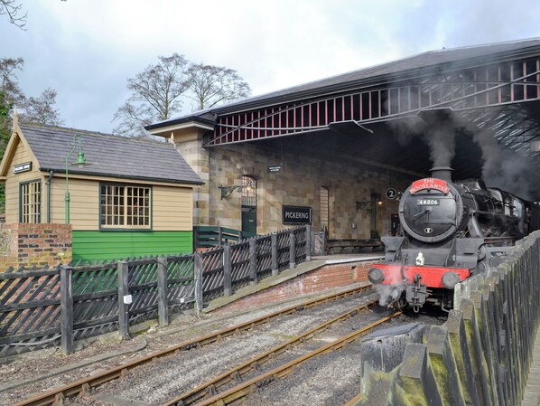 A vintage train station with a steam locomotive, a small building labeled 'Pickering,' and a platform. - 3 bedroom accommodation in Pickering (Pickering)