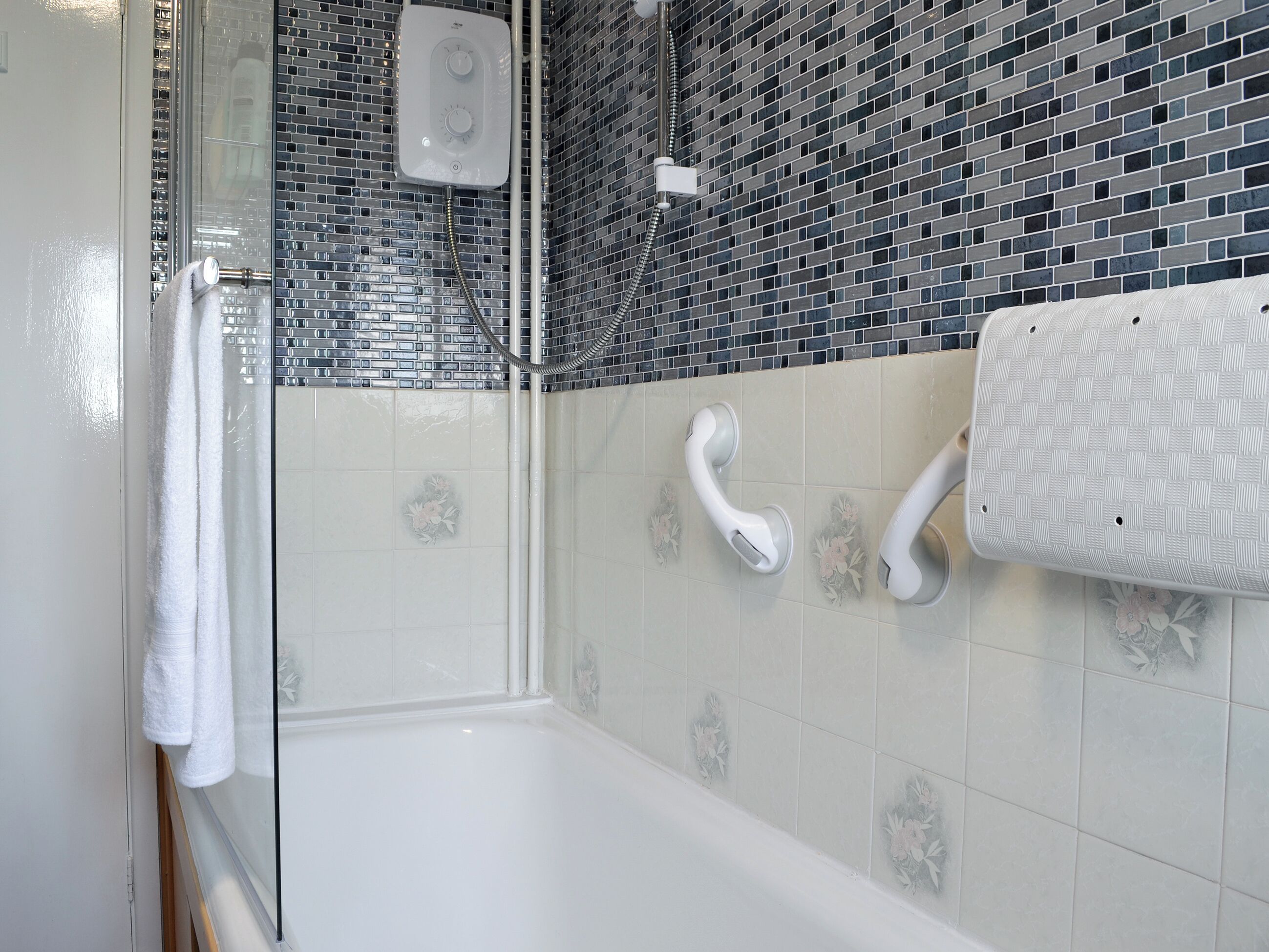 A bathroom with a bathtub, a shower, and a toilet.