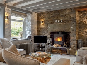 A cozy living room with a stone fireplace, a television, and comfortable seating. - Coach House Grasmere (Grasmere)