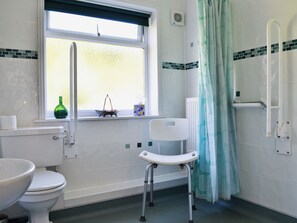 A bathroom with a toilet, a sink, a window, a shower with a curtain, and a grab bar. - 3 bedroom accommodation in Fitzhead, near Wivelscombe (Fitzhead, near Wivelscombe)