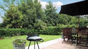 An outdoor patio with a grill, a bench, and a potted plant. - Looking for a romantic escape in Herefordshire’s rolling countryside. (Tarrington, near Ledbury)