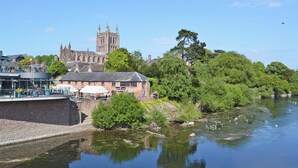 A riverside view with a historic building, a riverside cafe, and a bridge. - Looking for a romantic escape in Herefordshire’s rolling countryside. (Tarrington, near Ledbury)